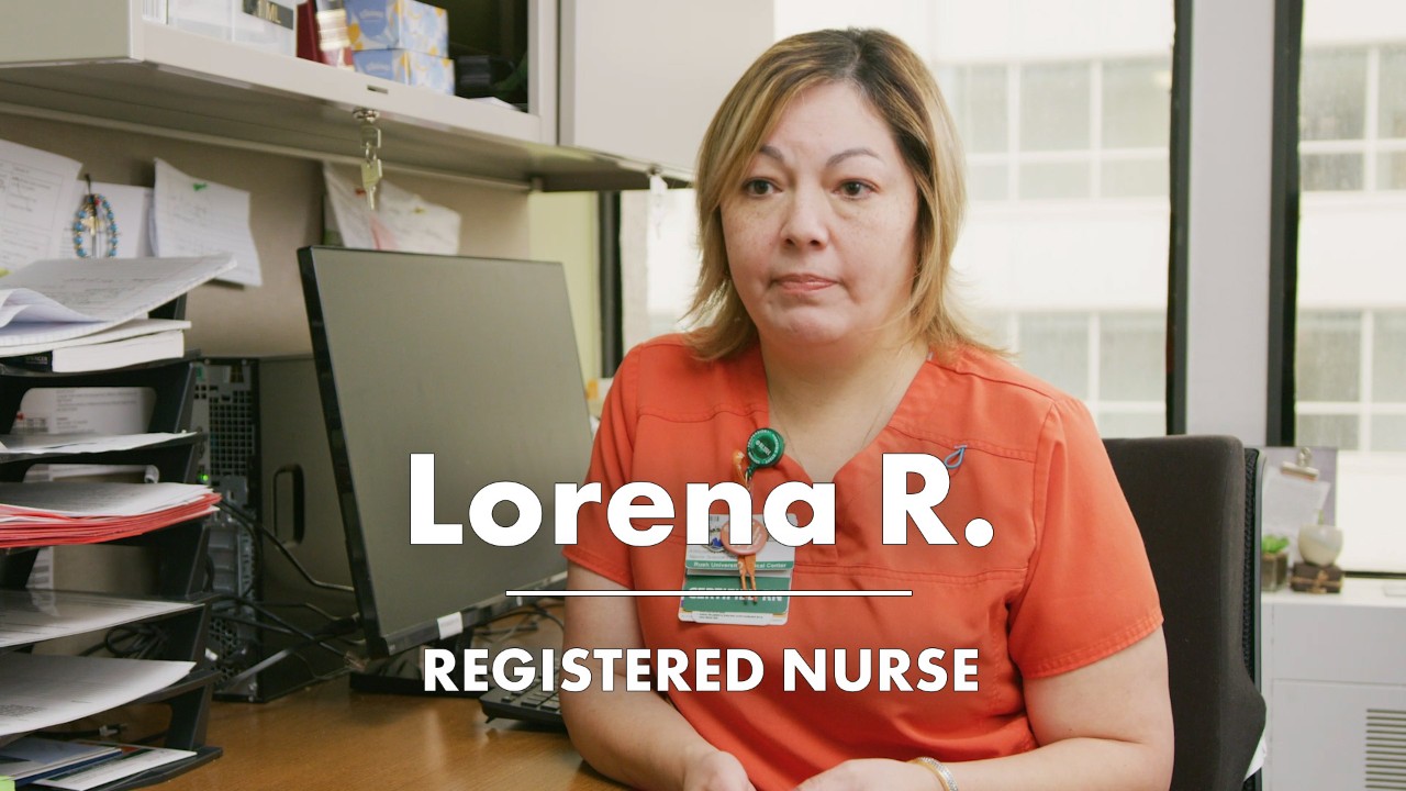 Nurse sitting behind desk and talking