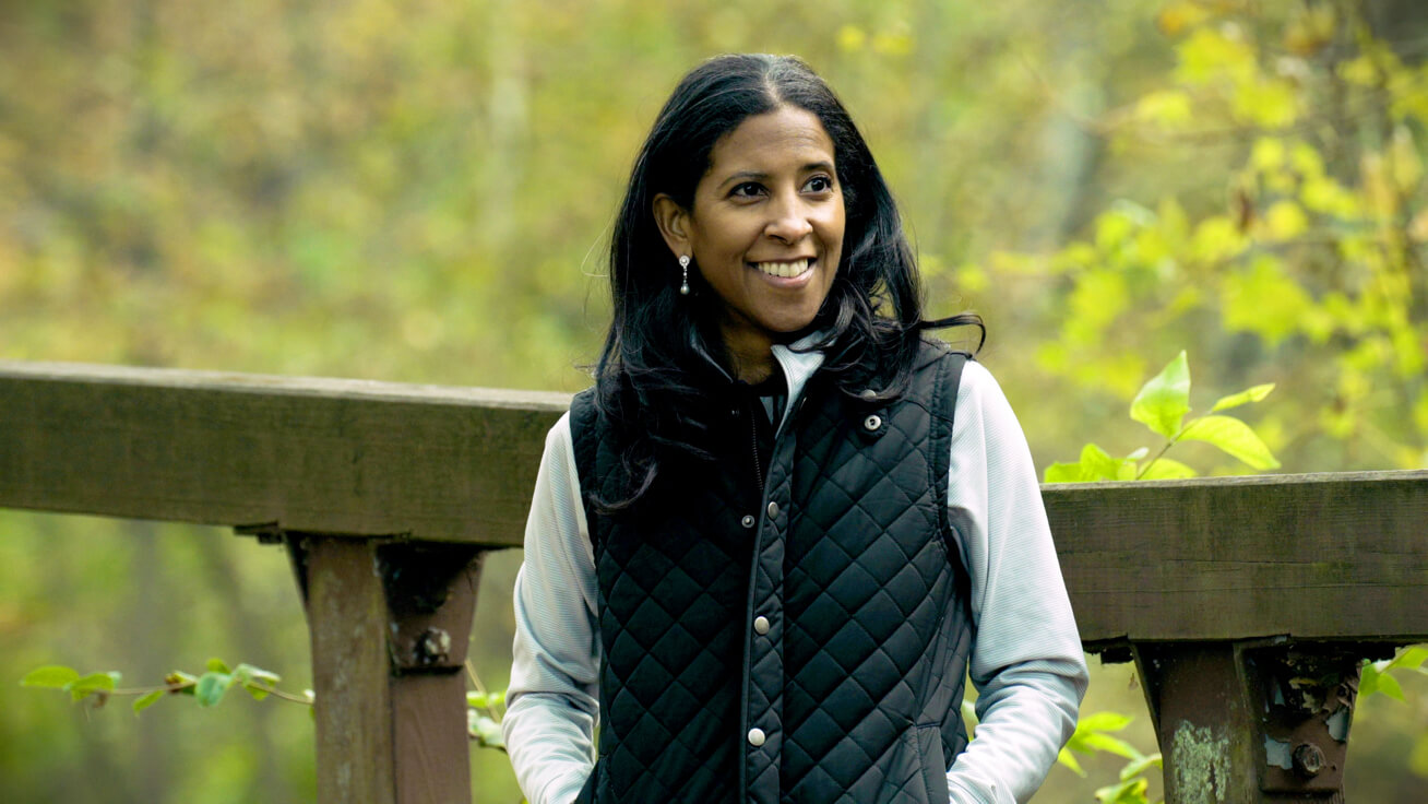 woman_standing_outdoors_smiling