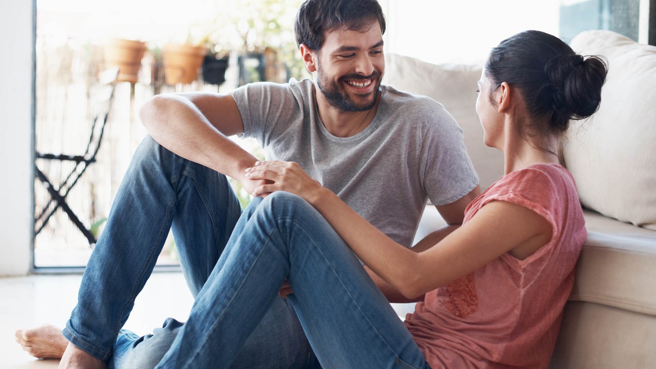 couple sitting on the floor laughing together