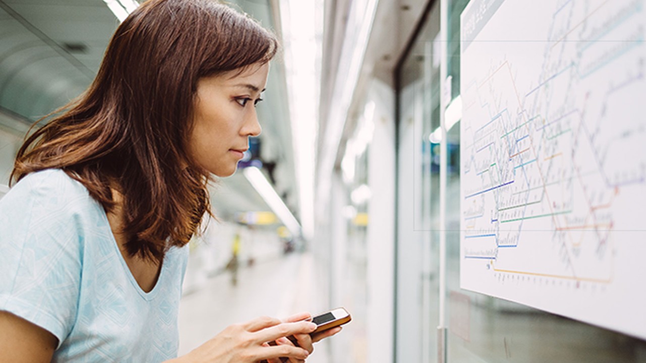 woman looking at a subway map