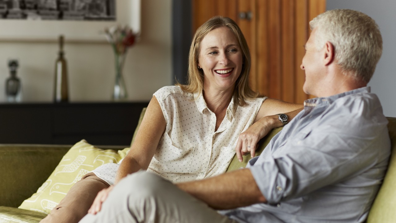 couple sitting on the couch laughing with each other