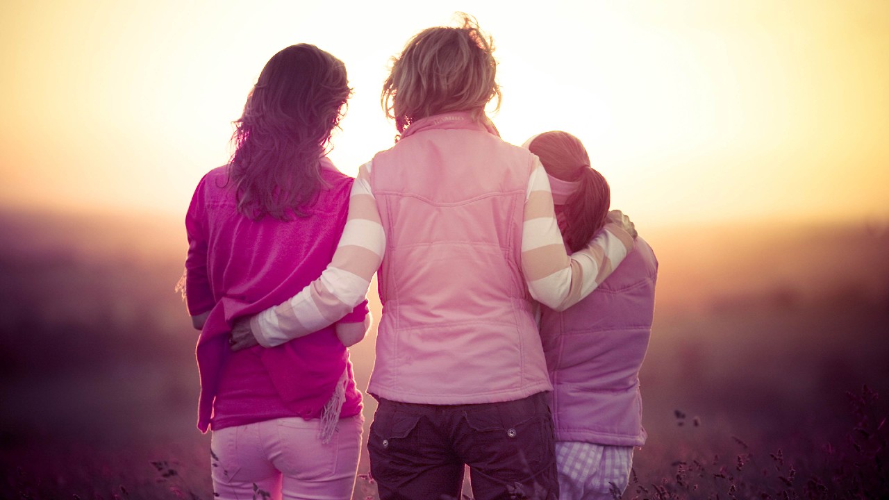 mom and two kids watching the sunset