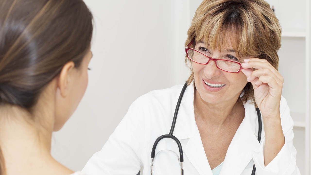 close up of doctor smiling at a patient