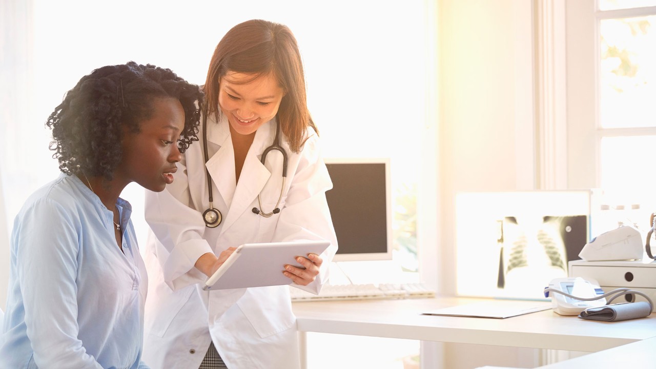 doctor and patient looking at an ipad together