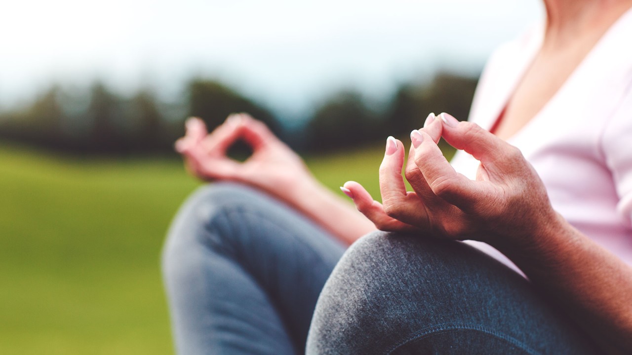 close up image of woman meditating