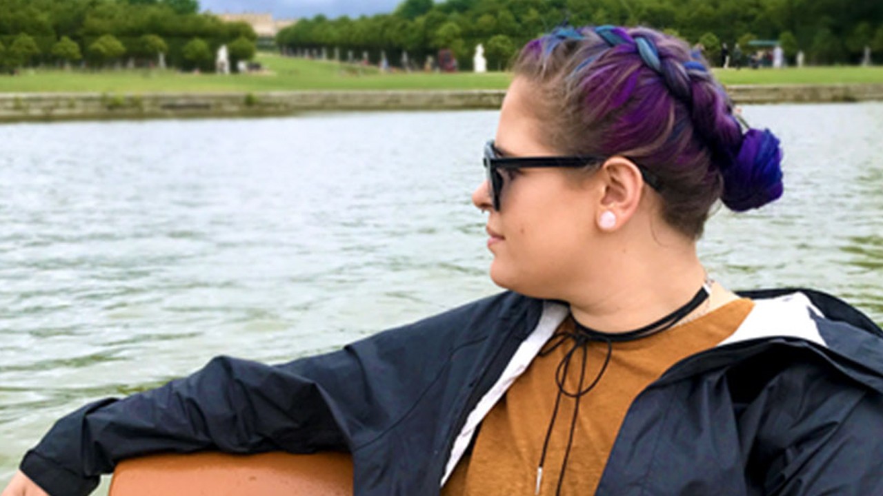 woman looking over her shoulder at the water