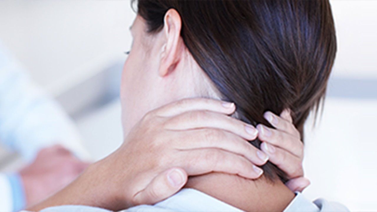 woman grabbing the back of her neck