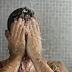 Man taking a cold shower