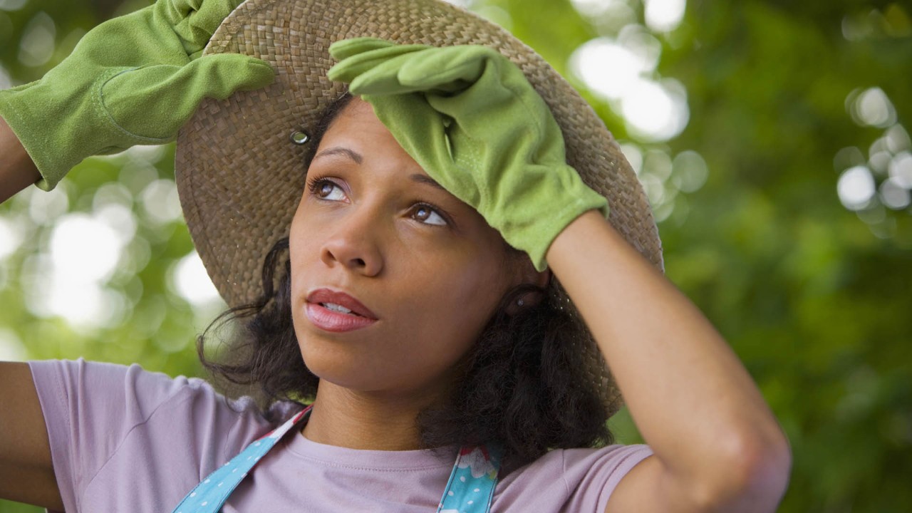 woman wiping sweat from her forehead