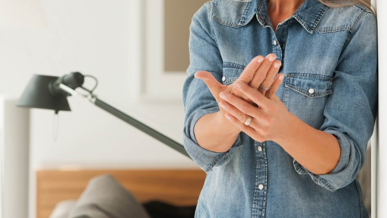 close up of a woman grabbing her hands