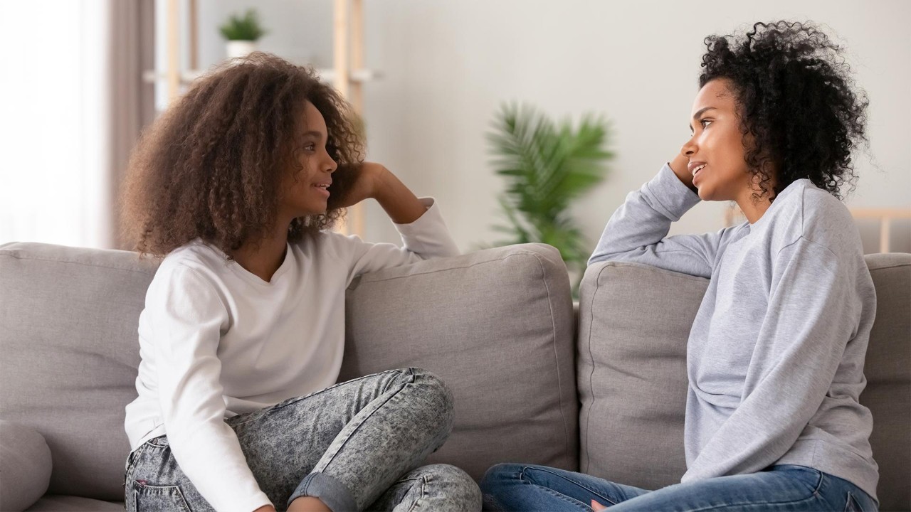 Two women talking on the couch